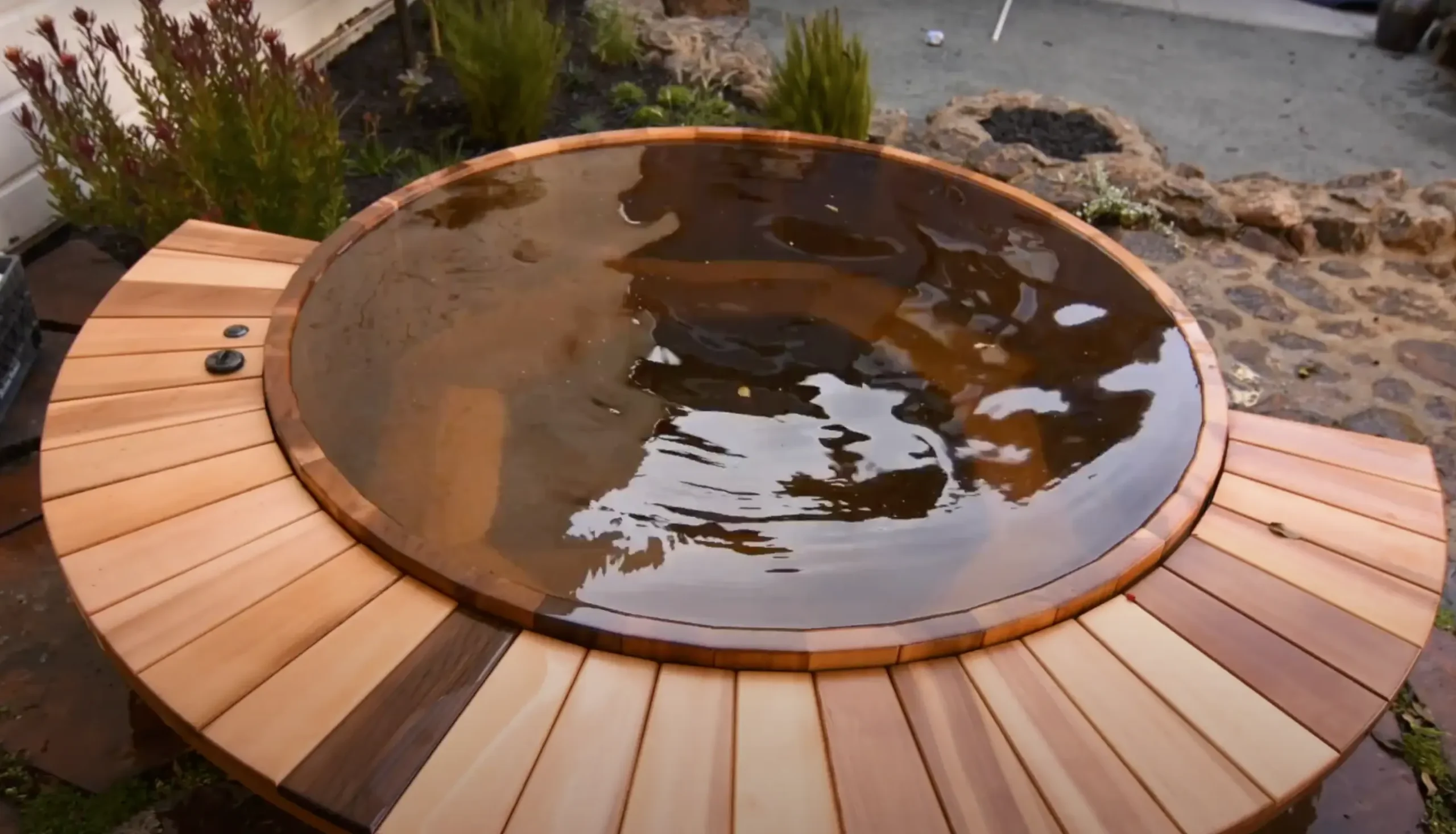 Custom Western Red Cedar hot tub in an outdoor setting, showcasing natural wood texture and elegant design.